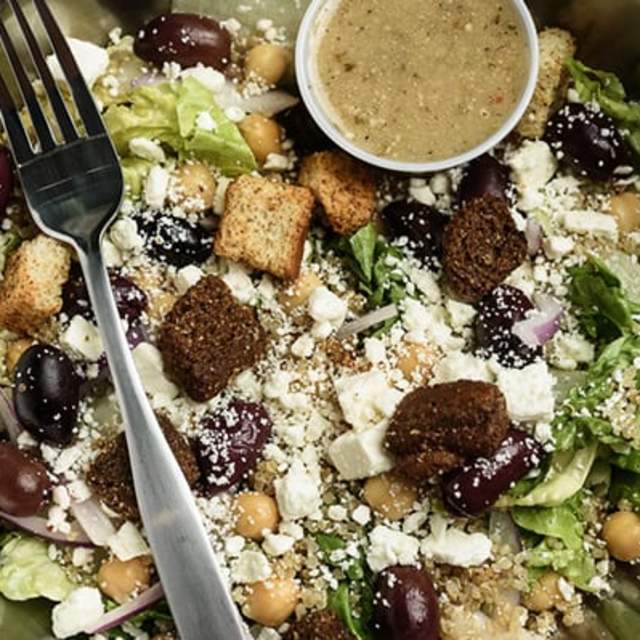 croutons, olives, navy beans, blue cheese, lettuce, and salad dressing from the greenhouse salad co
