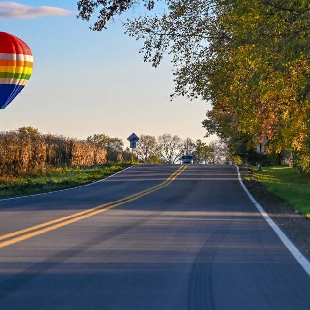 Hot air balloon over a roadway