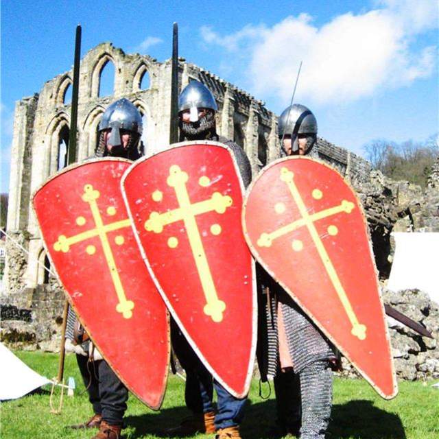 Image shows three people with armour and shields.