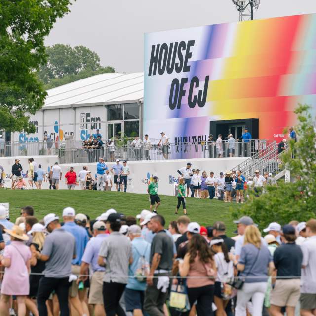 Large tent at a golf tournament with digital signage saying House of CJ