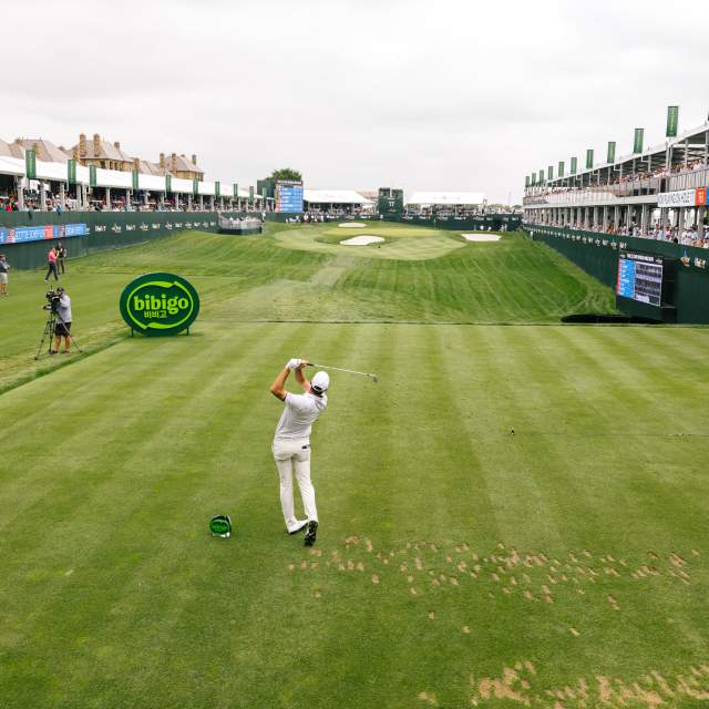 Man golfing on green in a tournament
