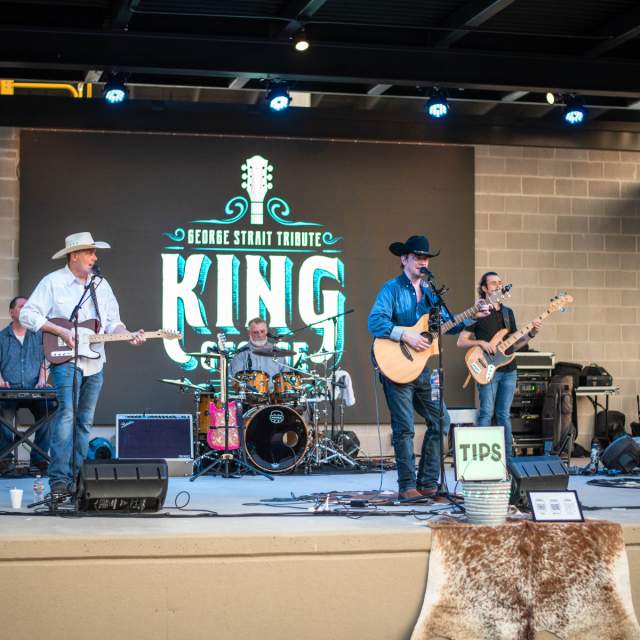 Country music singers on stage with guitars singing
