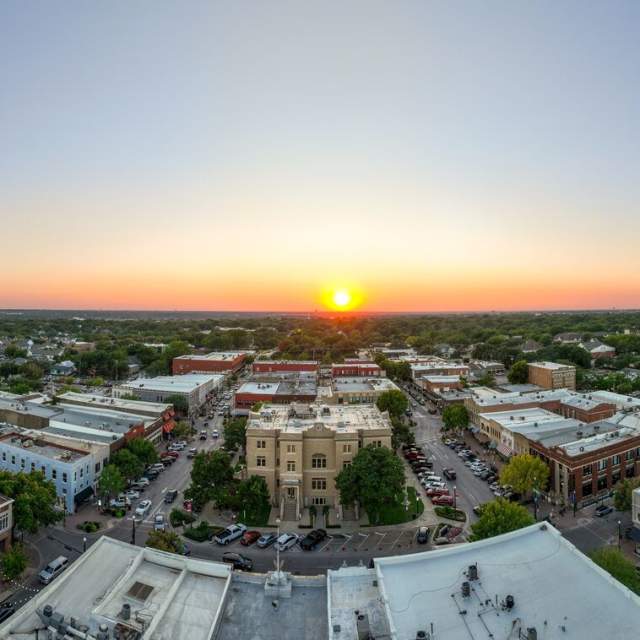 Yellow sun setting over the skyline in Downtown McKinney