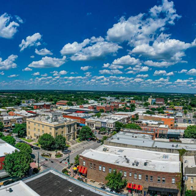 drone shot of downtown McKinney with blue sky and clouds