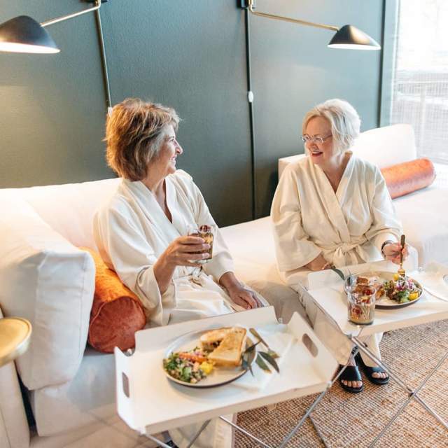 Two women relax at Pavitra Spa while having lunch
