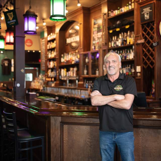 The Pub - owner standing in front of bar