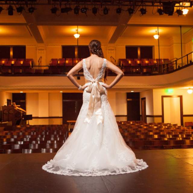 View of the back of a bride on stage at McKinney Performing Arts Center