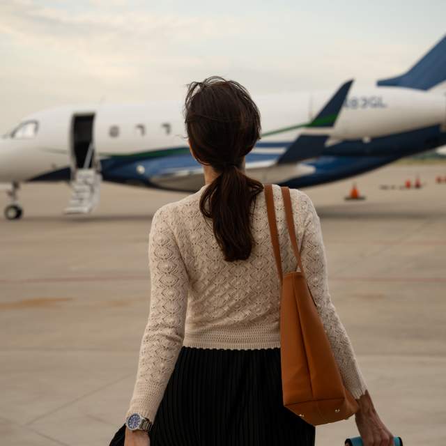 Women walking toward plane in background on tarmac