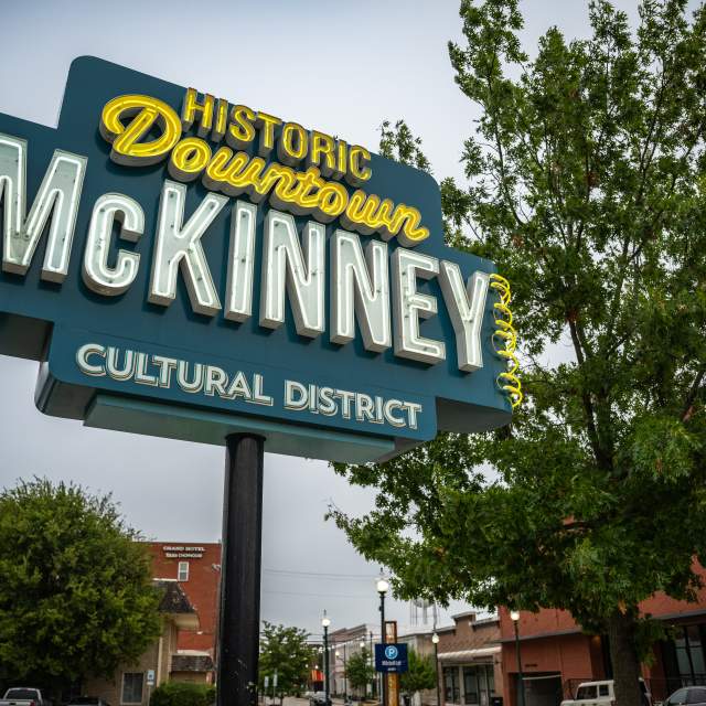 Blue and yellow neon historic downtown sign.