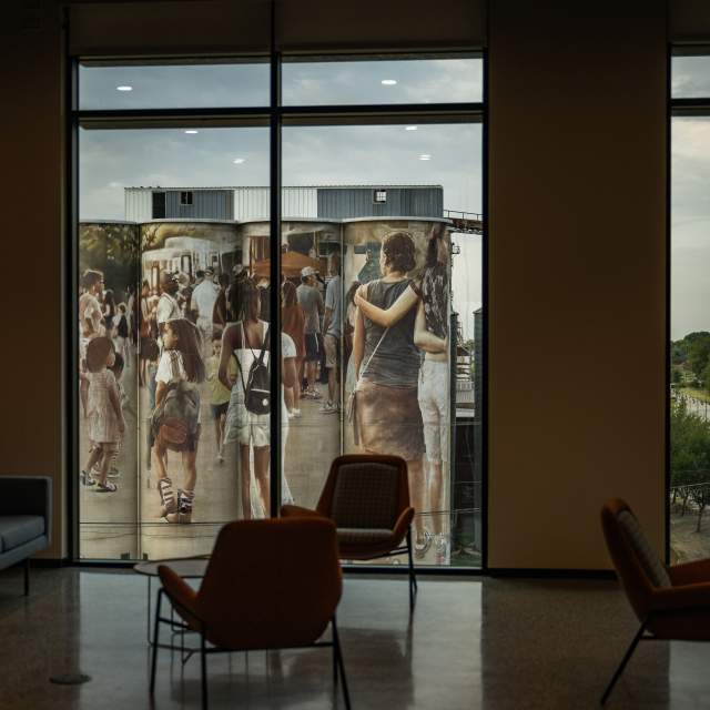 View of the silos outside of city hall from the point of view in the building looking out of a window