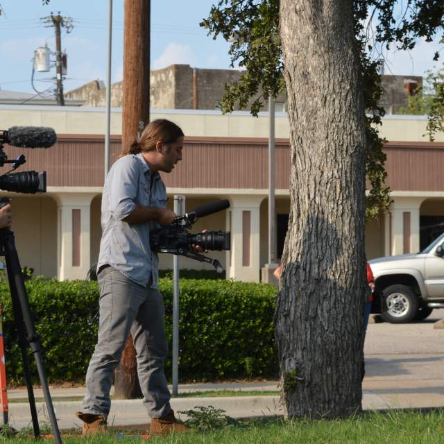 Two-man film crew shooting a movie scene in downtown McKinney
