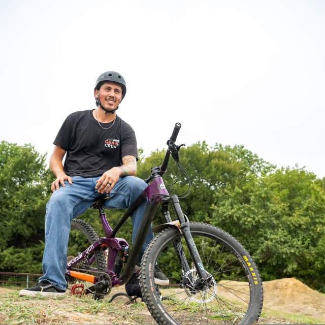 Man sitting on a bmx bike at a park in McKinney