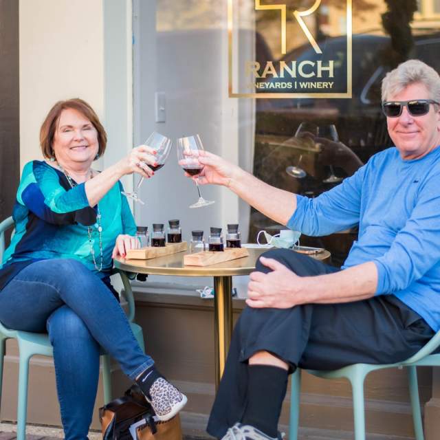 Man and woman enjoying a glass of wine on a patio
