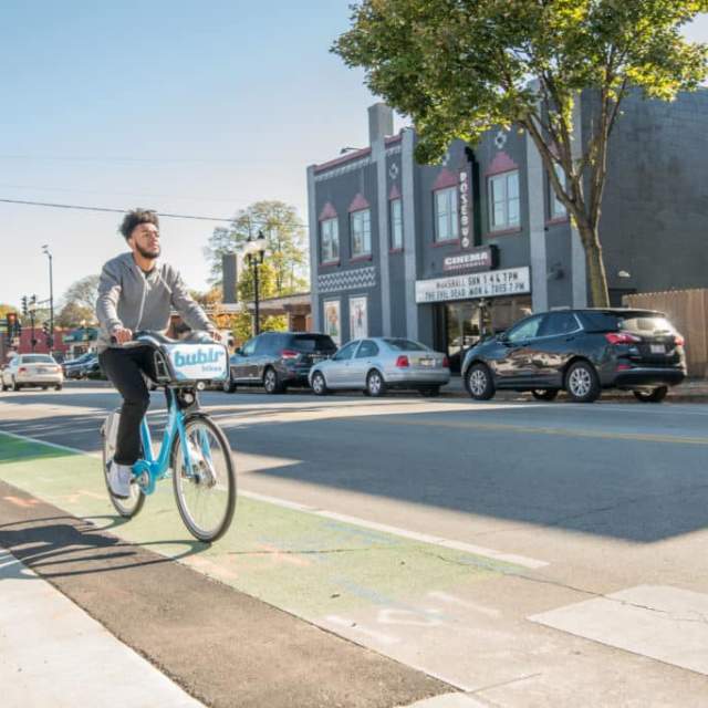 Person on a Bublr Bike riding in the bike lane in Wauwatosa, WI