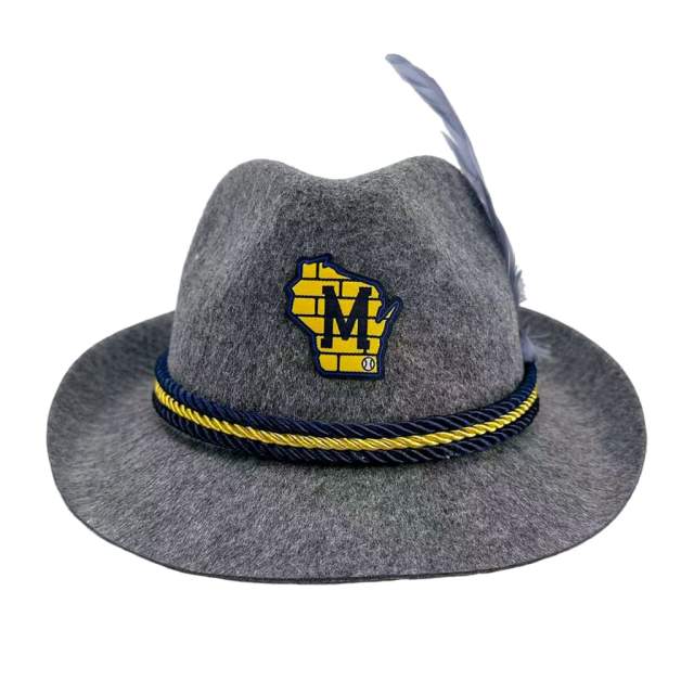 A gray felt hat with a wide brim, a feather on the side, and a braided navy and yellow band, featuring a Milwaukee Brewers “M” logo patch on the front.