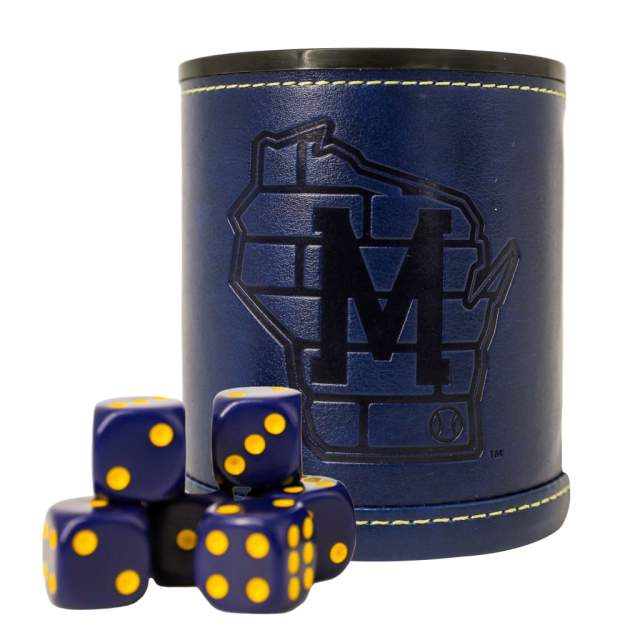 A navy blue dice cup with stitched trim and an embossed Milwaukee logo shaped like the state of Wisconsin, shown with several matching blue dice featuring yellow dots.