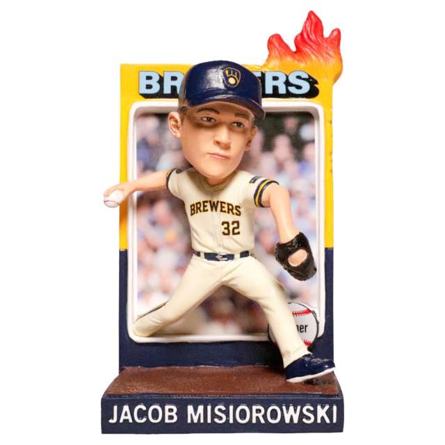 A bobblehead figurine of Milwaukee Brewers pitcher Jacob Misiorowski in a cream uniform and navy cap, posed mid-pitch with a baseball in hand. The base displays his name, and a flame graphic appears above the Brewers backdrop behind him.