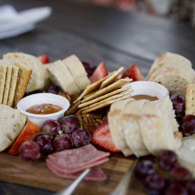 Meats, cheeses and crackers on a wooden board