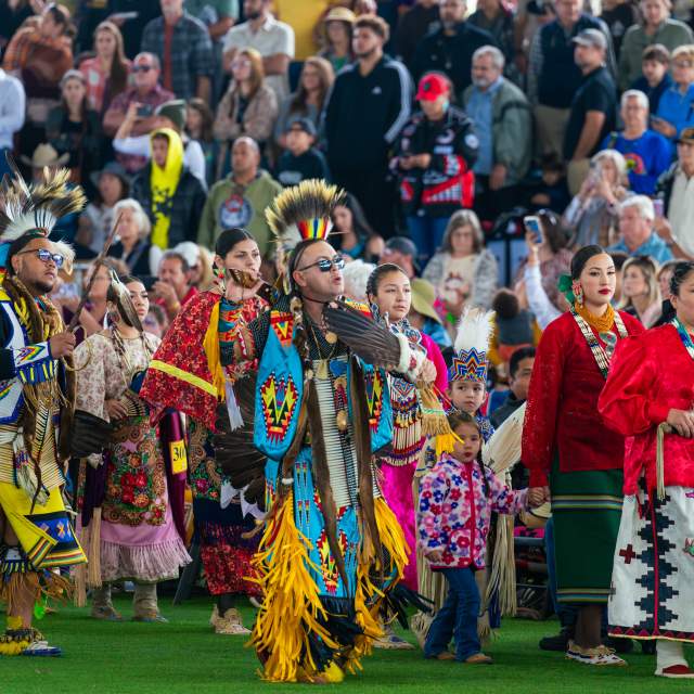 Group of people dressed in Indigenous garb at the Poarch Creek Indians' Annual Thanksgiving Pow Wow