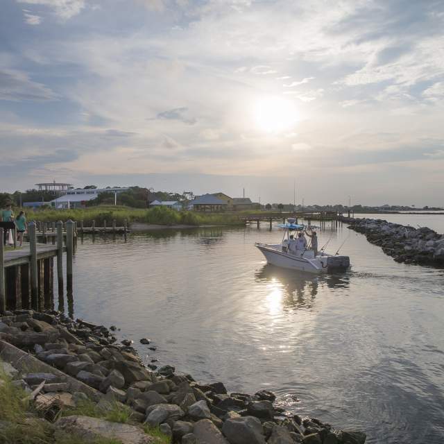 Small boat coasting on the waters of Dauphin Island