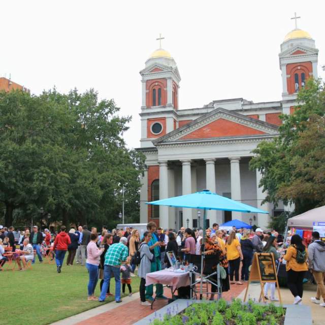 Cathedral Square: park with crowd of people in front of a large church