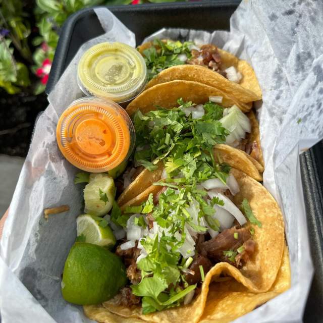 tray of tacos and sauces
