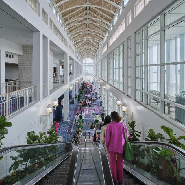 Mobile Convention Center concourse with escalator and group of people