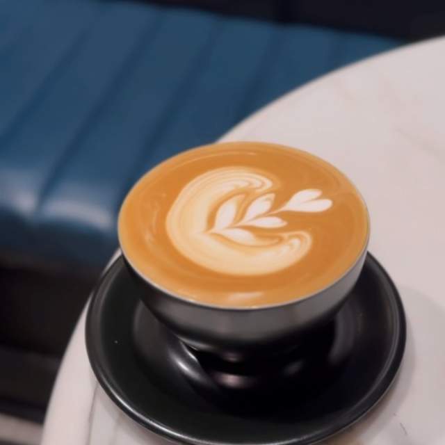 Latte with a leaf/heart design in foam