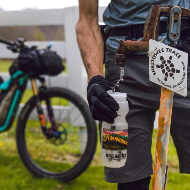 Alternate - Cyclist filling water bottle