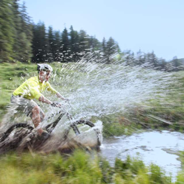 Splashing into water on a mountain bike in New Mexico