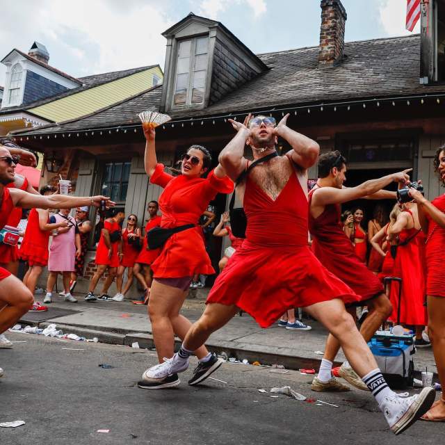 Red Dres Run participants outside of Lafitte's Blacksmith Shop in the French Quarter