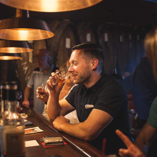 man drinking bourbon at prohibition bourbon bar in newport ky