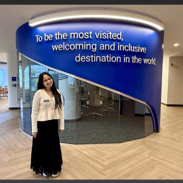 Manuela Rodriguez posing by sign
