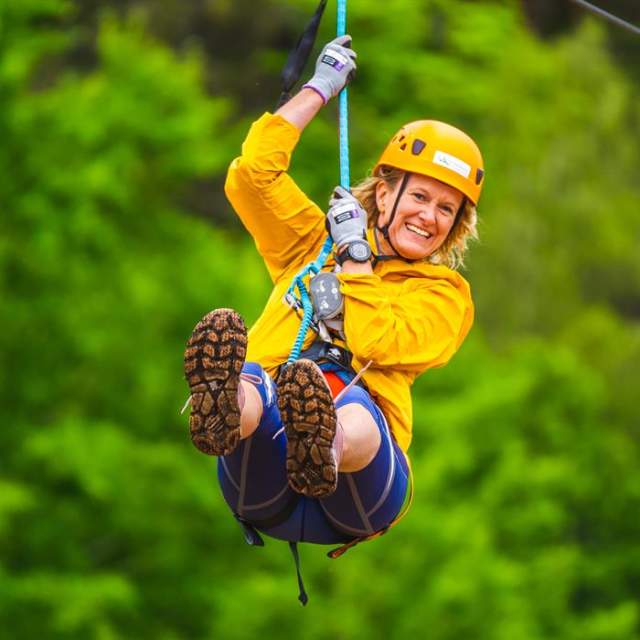 Kvinne smiler i zip line