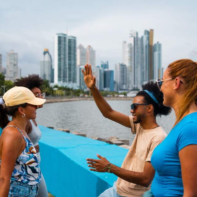 Friends enjoying at Cinta Costera, in the background you can see the skyline of Panama City, Panamá