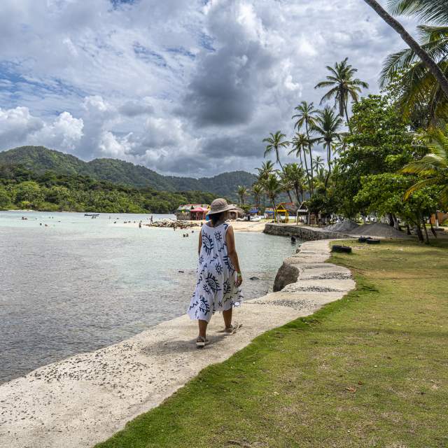 Woman walking at the shore of Caribbean Mamey Island