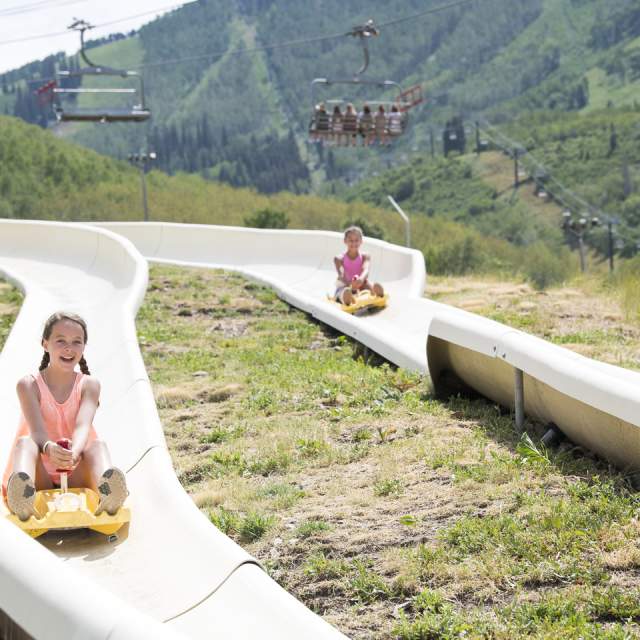 Two people enjoying the alpine slide at park city mountain
