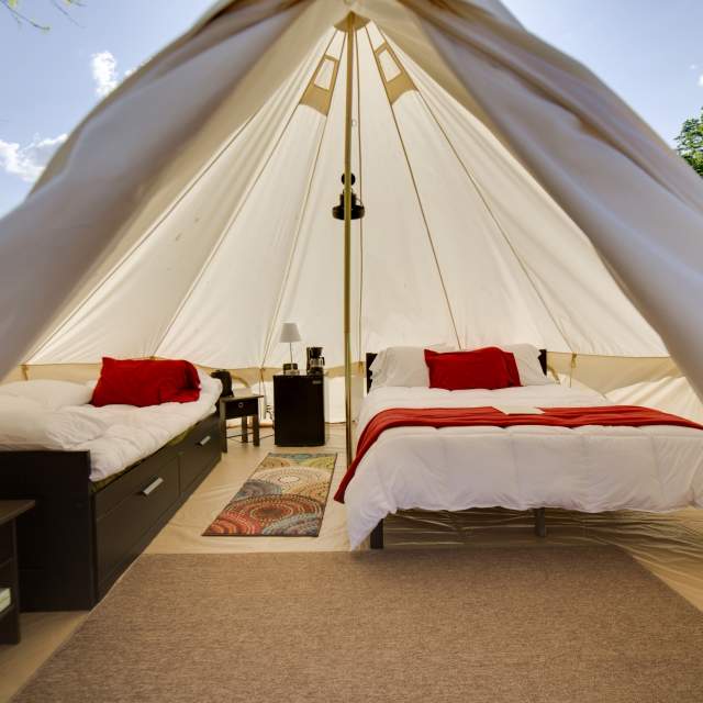 Interior of a luxury glamping tent with two beds at the Shawnee Inn in the Pocono Mountains.