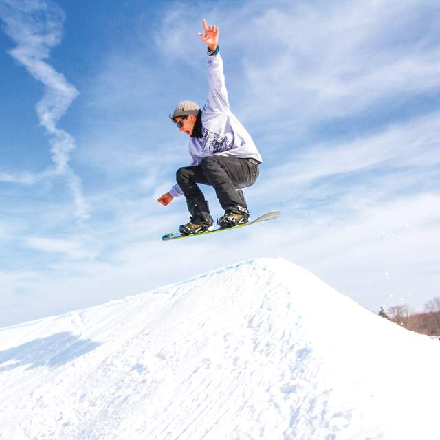 Showboarder on a jump at Snow Park at Alpine Hills