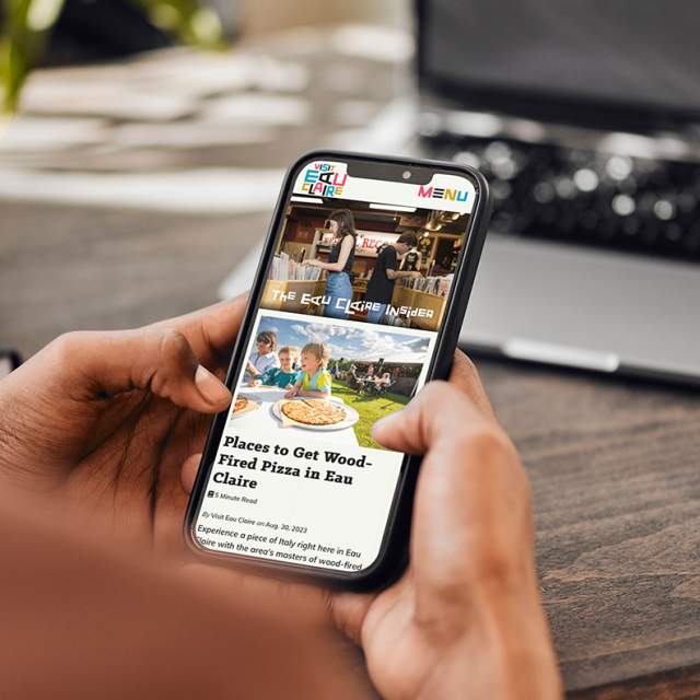 Person looking at the Eau Claire website on a mobile device