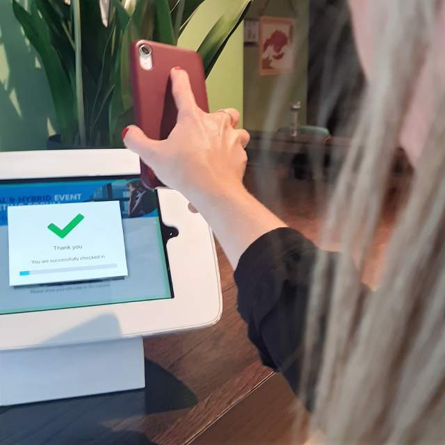 person using check-in kiosk
