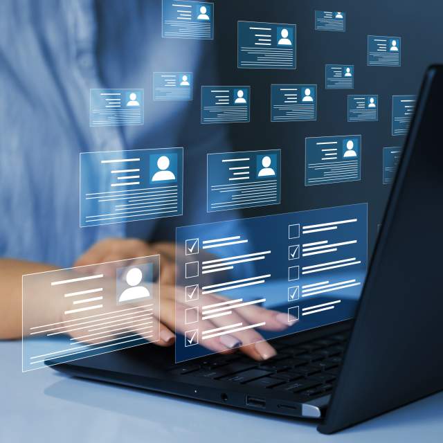 A person on a laptop with persona icon bubbles around them.