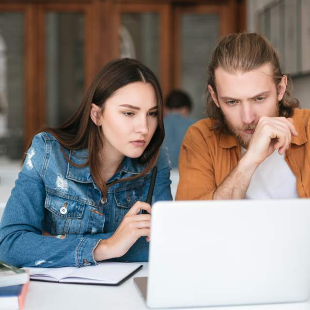 Man and woman looking at computer