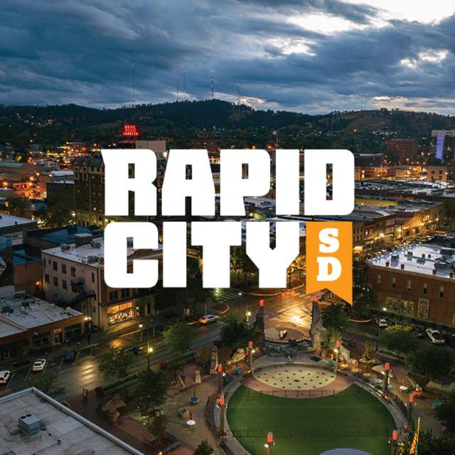 Visit Rapid City 2024 Visual Identity Logo overlaying an image of Rapid City South Dakota