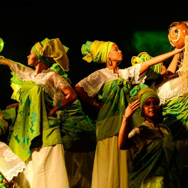 Group of women wearing green and white dresses
