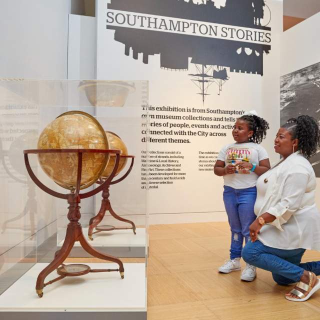 Adult and child looking at globes in Seacity Museum