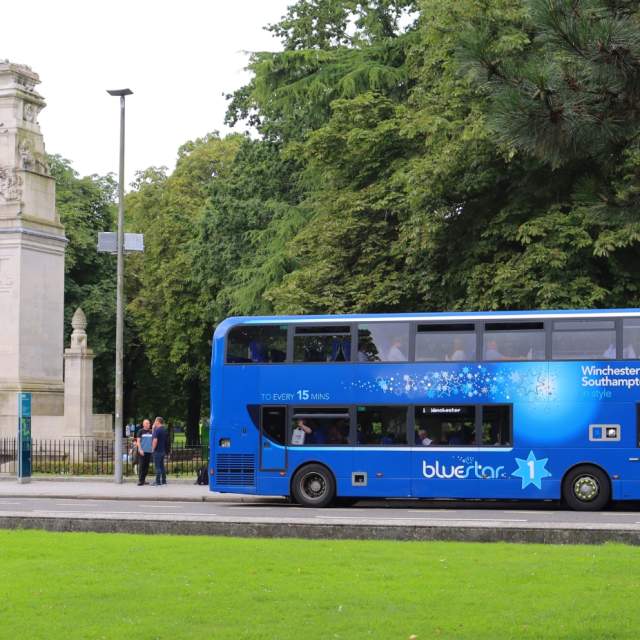 Number one Bluestar bus picking up passengers at bus stop outside the Cenotaph