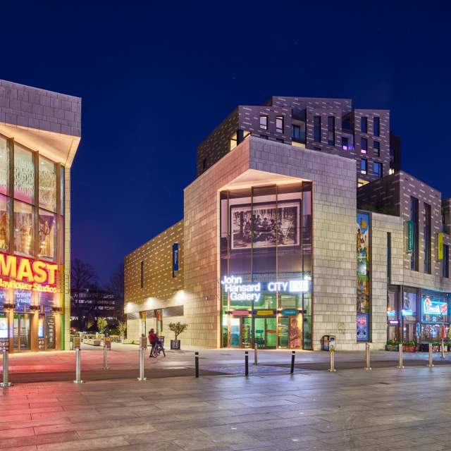 The cultural quarter at night showing John Hansard Gallery and Mayflower Studios buildings with signage lit up