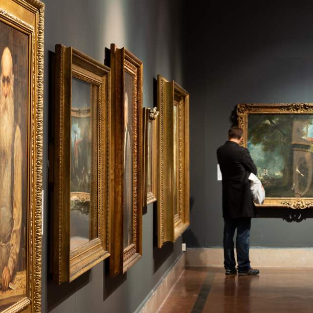 Person looking at peices of art at Southampton City Art Gallery