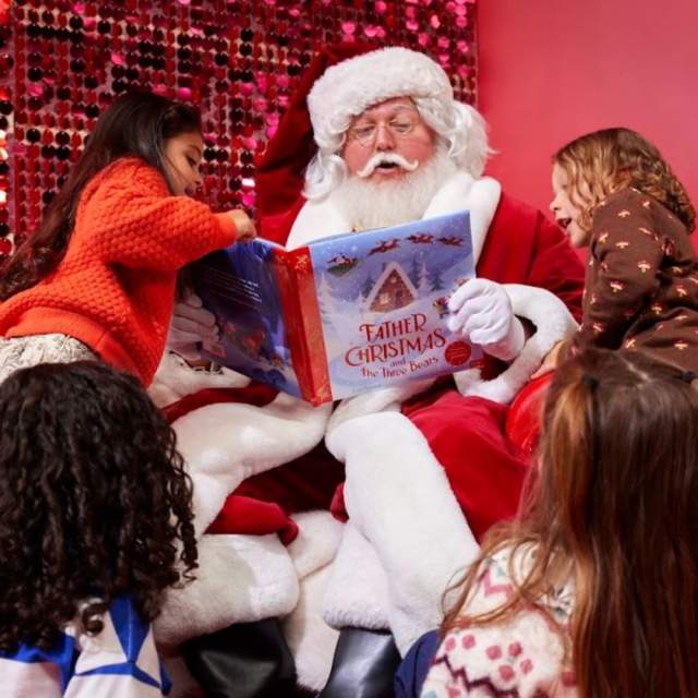 Father Christmas at John Lewis reading to a group of children